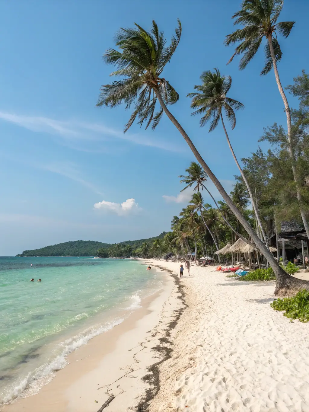 A vibrant photo of Long Hai beach, showcasing its clear waters and sandy shores, with a Trần Phi Travel Car van parked nearby, suggesting convenient transportation.